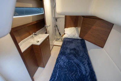 Luxurious cabin interior of 2020 Princess F55 yacht with bed and sink.