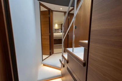 Interior of 2020 Princess F55 yacht with wooden stairs and modern design.
