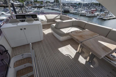 Luxurious 2020 Princess F55 yacht deck with seating and tables, docked at a marina.