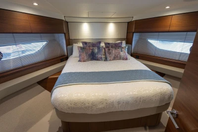 Luxurious bedroom interior of 2020 Princess F55 yacht with elegant bedding and modern design.