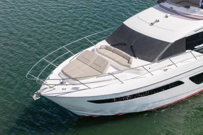 Luxurious 2020 Princess F55 yacht cruising on calm waters, showcasing sleek design and spacious deck.