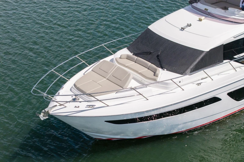 Luxurious 2020 Princess F55 yacht cruising on calm waters, showcasing sleek design and spacious deck.