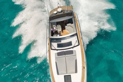 2018 Princess V40 yacht cruising on clear turquoise waters, aerial view.