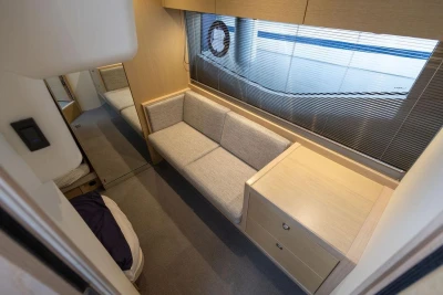 Interior of 2018 Princess V40 yacht with modern sofa and wooden cabinetry.