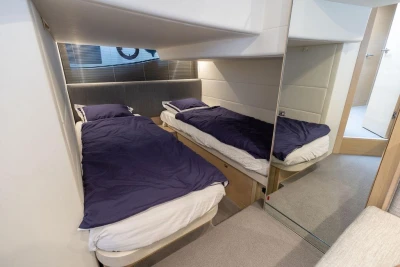 Interior of 2018 Princess V40 yacht cabin with twin beds and modern design.