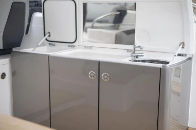 Modern kitchenette on a 2018 Princess V40 yacht with sleek cabinetry and sink.