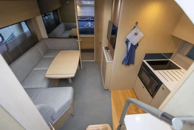 Interior of 2018 Princess V40 yacht with modern kitchen and cozy seating area.