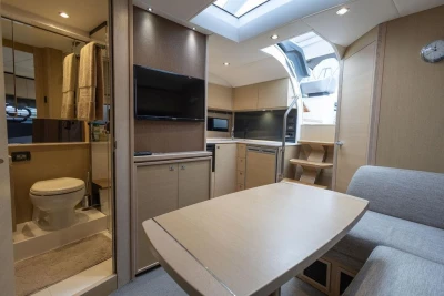 Luxurious interior of 2018 Princess V40 yacht with modern kitchen and cozy seating area.