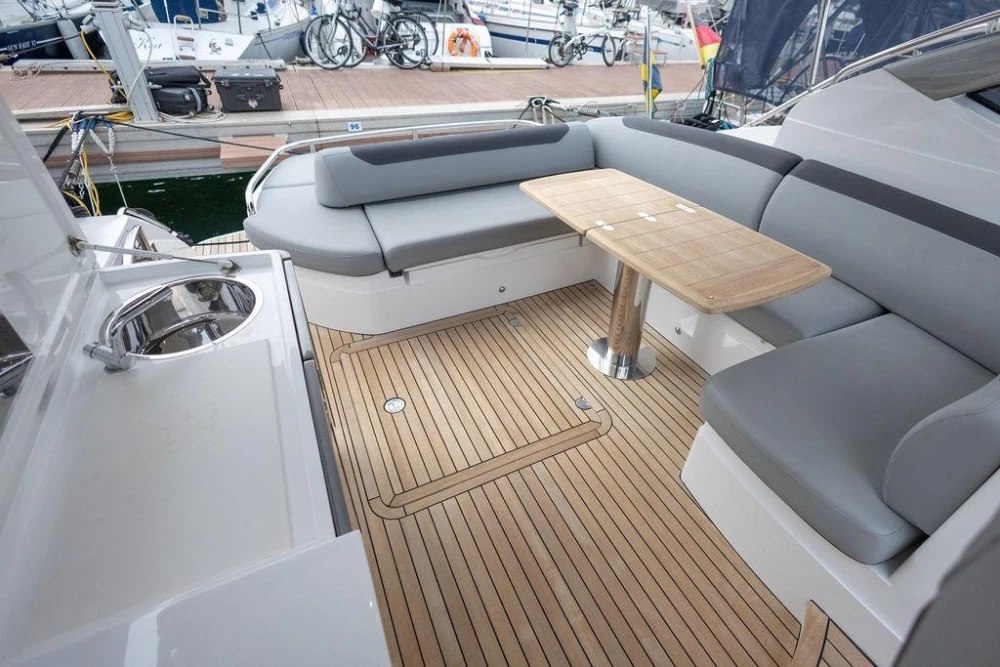 Luxurious 2018 Princess V40 yacht deck with seating, table, and sink.