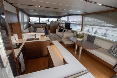 Interior of a luxury yacht with a modern kitchen and stylish living area.