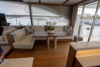 Interior of the Princess 68 yacht with elegant seating area and table.