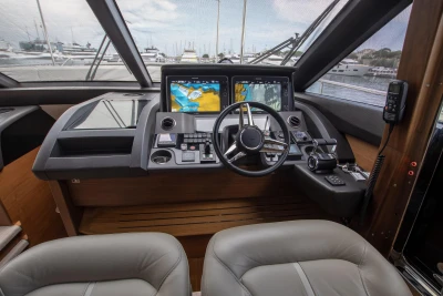 Helm of a 2016 Princess 68 with modern navigation systems and comfortable seating.