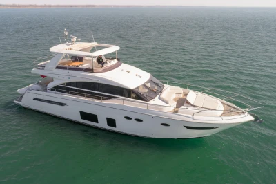 Luxurious white yacht on calm water with spacious deck and modern design.