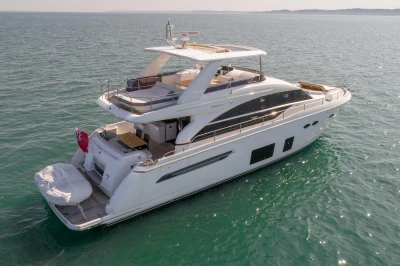 Luxury yacht on calm water with spacious deck and sleek lines.