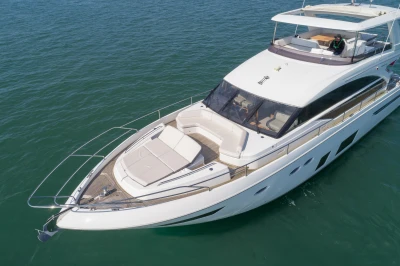 Luxurious white yacht on calm water with spacious deck and modern design.