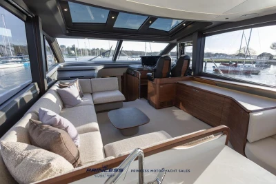 Luxurious interior of 2026 Princess S65 yacht with elegant seating and panoramic windows.