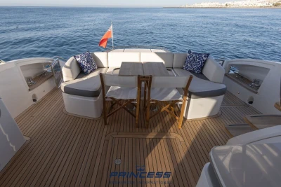 Luxurious 2019 Princess S60 yacht deck with seating, table, and ocean view.