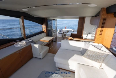 Luxurious interior of 2019 Princess S60 yacht with ocean view and elegant furnishings.