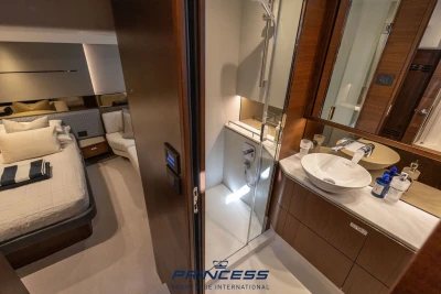Luxurious interior of 2019 Princess S60 yacht featuring bedroom and modern bathroom design.
