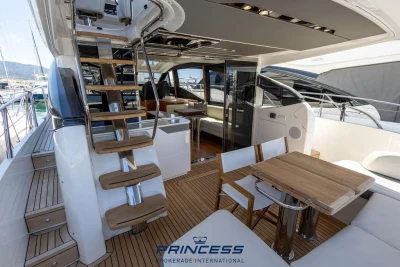 Luxurious 2019 Princess S60 yacht interior with elegant wooden staircase and seating area.