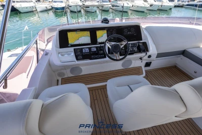 Luxurious 2019 Princess S60 yacht helm with modern navigation system and plush seating.