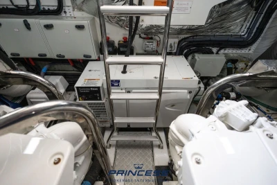 Engine room of 2019 Princess S60 yacht with Cummins Onan generator and control panels.