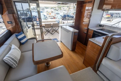 Luxurious interior of 2018 Princess S60 yacht with modern furnishings and marina view.