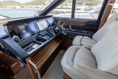 Luxurious 2018 Princess S60 yacht cockpit with modern navigation displays and plush seating.