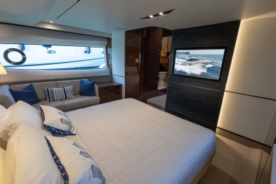 Luxurious 2018 Princess S60 yacht bedroom with elegant decor and ocean view.