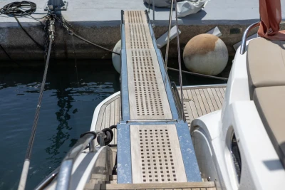 Gangway of 2018 Princess S60 yacht docked at marina with mooring lines.