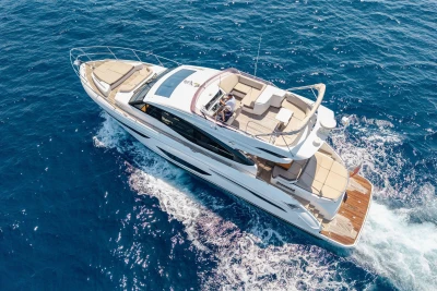 2018 Princess S60 yacht cruising on open blue sea, aerial view.