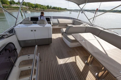 The image shows the deck of a 2022 Princess F55 yacht with elegant seating.