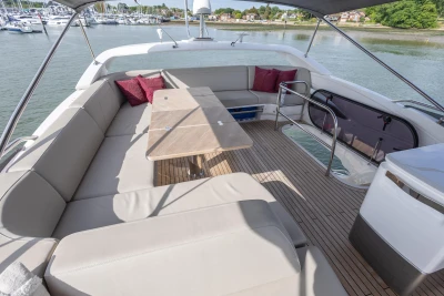 The image shows the deck of a 2022 Princess F55 yacht with comfortable seating.