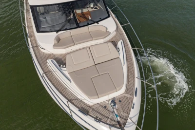 Aerial view of a luxury yacht with sleek sun loungers on the foredeck.