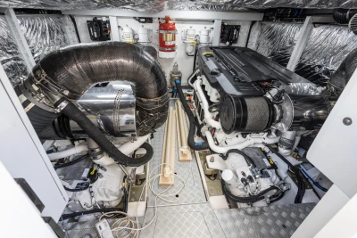 Engine room of the Princess F55 yacht with two large engines and shiny metal components.