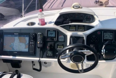 Helm of a 2017 Princess 43 yacht with navigation equipment and steering wheel.