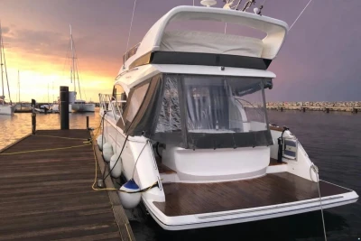 Luxury Princess 43 yacht docked at sunset, 2017 model, with serene marina backdrop.