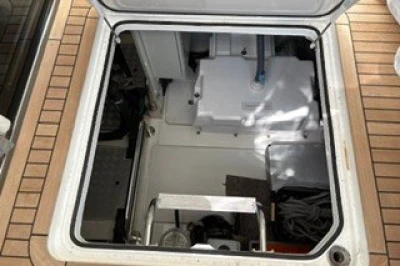 Open hatch on 2017 Princess 43 yacht, revealing storage and mechanical components.