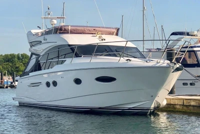 Luxury 2017 Princess 43 yacht docked in marina, sleek design and modern features.