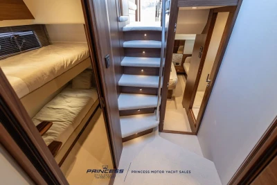 Luxurious interior of 2025 Princess F50 yacht with elegant stairs and cozy cabins.