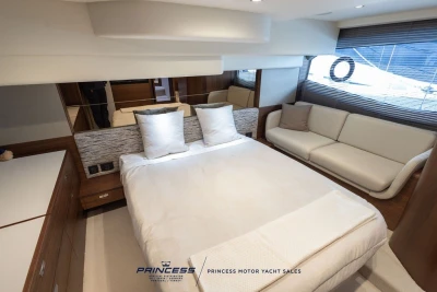 Luxurious bedroom interior of 2025 Princess F50 yacht with modern furnishings.