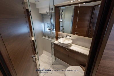 Luxurious bathroom interior of 2025 Princess F50 yacht with modern fixtures and wooden accents.