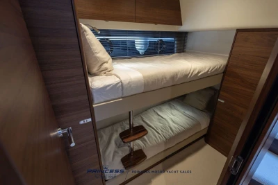 Bunk beds in a luxurious 2025 Princess F50 yacht cabin with wooden finishes.