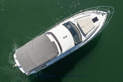 Aerial view of 2025 Princess F50 yacht cruising on green water.