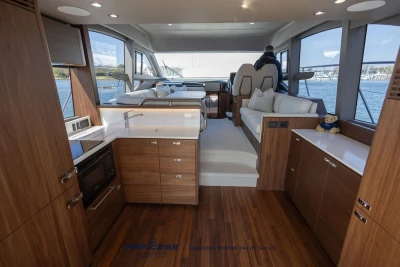 Luxurious interior of 2025 Princess F50 yacht with modern kitchen and seating area.