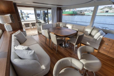 Luxurious interior of 2026 Princess X80 yacht with elegant seating and waterfront view.