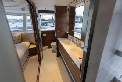 Luxurious 2026 Princess X80 yacht interior with modern bathroom and cozy bedroom.