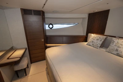Luxurious cabin interior of 2026 Princess X80 yacht with elegant wood finishes.