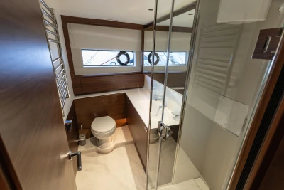 Luxurious bathroom interior of 2026 Princess X80 yacht with modern fixtures and wooden accents.