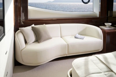 Luxurious interior of 2026 Princess X80 yacht with elegant white sofa and ocean view.